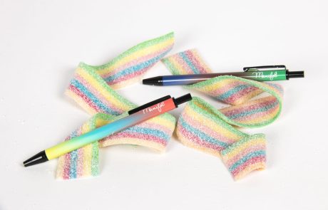 Bolígrafos mini colores arco iris sobre gominolas